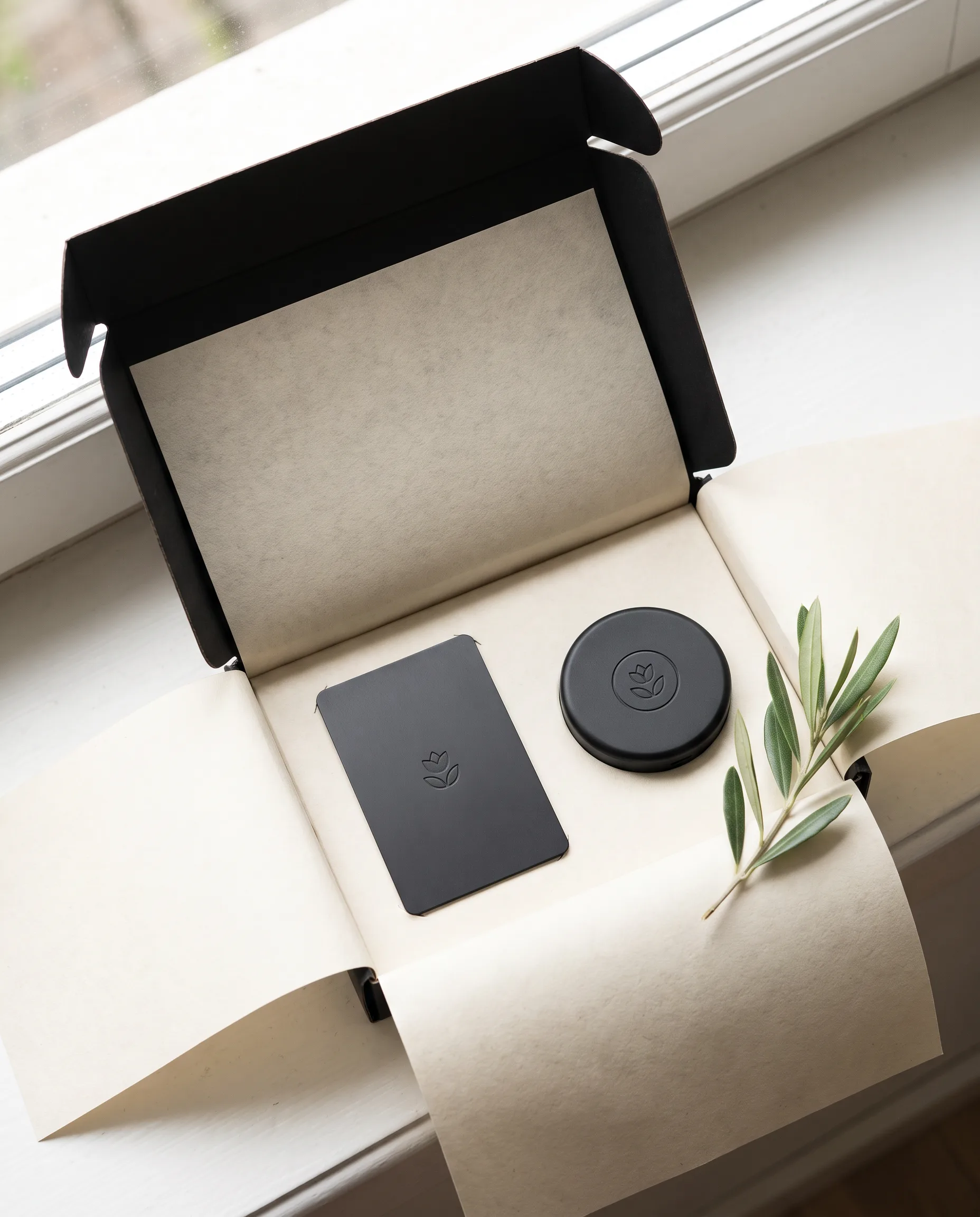 A Bloom Card and a round Bloom Pod in an open black gift box
